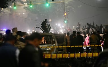 Officials inspect damaged vehicles at the site after a car explosion near the historic Red Fort in New Delhi, India, Monday, Nov. 10, 2025. (AP Photo/Manish Swarup)