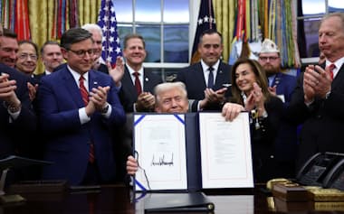 つなぎ予算案に署名するトランプ大統領(12日、ワシントン)=ロイター