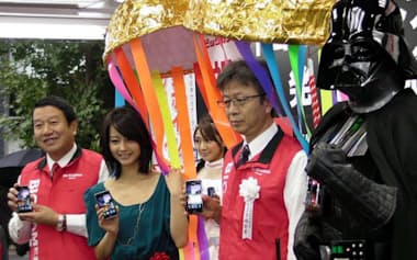写真　左からNTTドコモの山田隆持社長、堀北真希さん、ビックカメラの宮嶋宏幸社長、ダース・ベイダー