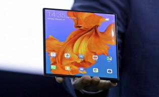 ファーウエイの端末は山折り型(左)。広げるとタブレットに=AP ファーウエイの端末は山折り型(左)。広げるとタブレットに=AP