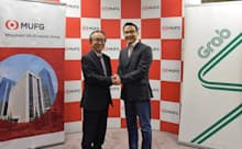 資本業務提携を発表した三菱UFJ銀行の亀沢宏規副頭取(左)とグラブのミン・マー社長(2月25日、東京・千代田)
